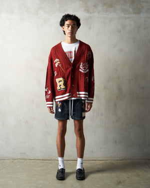 Ryoko Rain School for Artists and Athletes. Model wearing a maroon cable knit cardigan and artist-black shorts