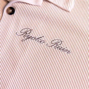 Ryoko Rain ivory pleated button-up shirt with Ryoko Rain cursive embroidery. Vertical ribbing detail.