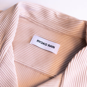 Closeup photo of Ryoko Rain Ivory pleated button-up collar. Ryoko Rain clothing label.